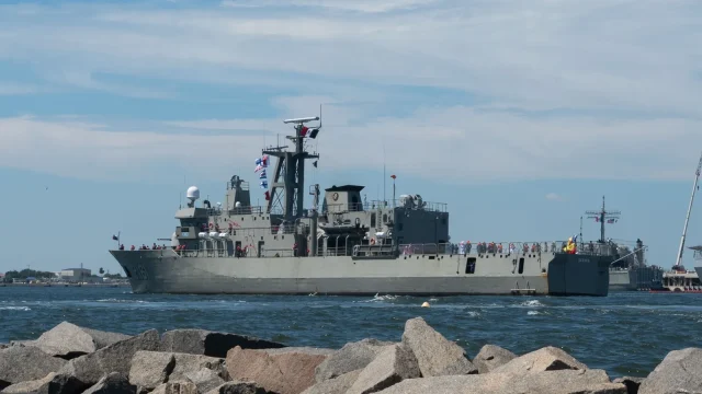 Mexican Navy patrol vessel ARM Oaxaca underway with signal flags flying as it arrives at a U.S. naval station