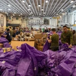 Sailors sort mail and packages at sea
