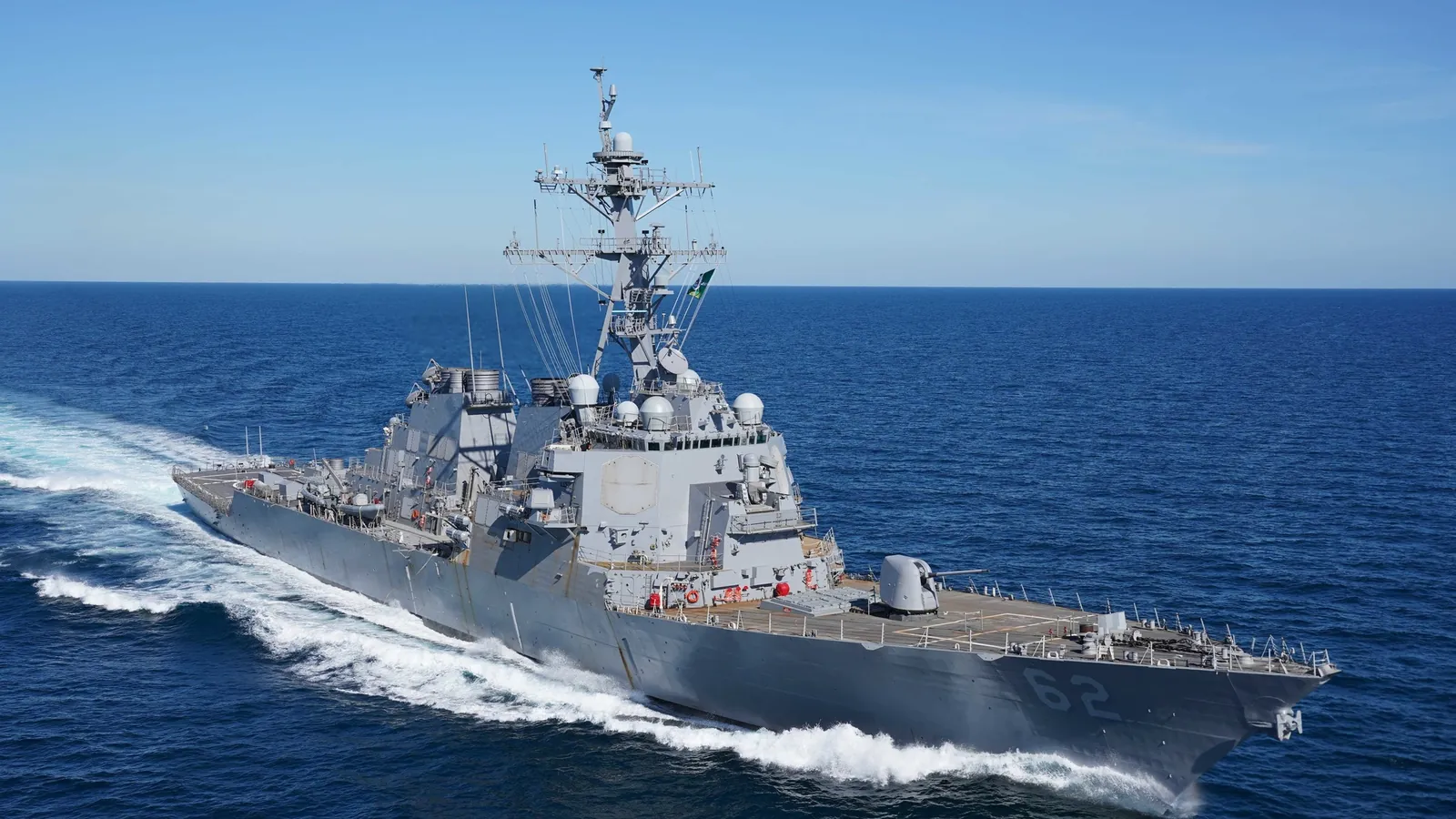 The destroyer USS Fitzgerald, hull number 62, under way at speed on a calm blue sea during sea trials off the Mississippi Gulf Coast